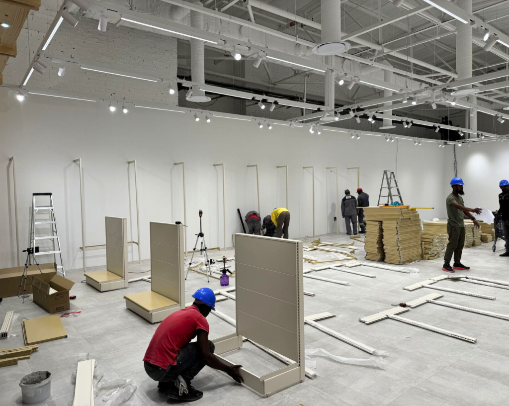Fixture supplier setting up retail shelves on site
